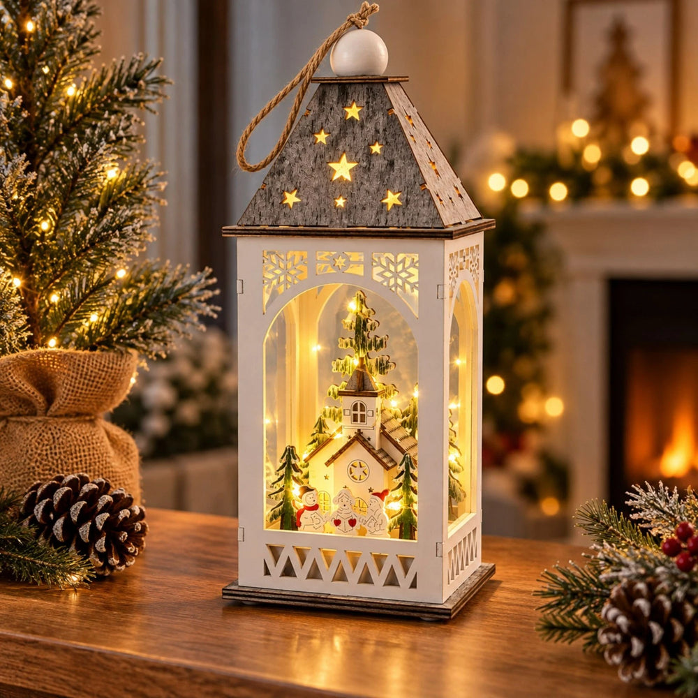 A decorative white lantern with a gray star-topped roof and warm internal holiday lights, displayed on a woden table in a wqarm background setting with a tree and garland