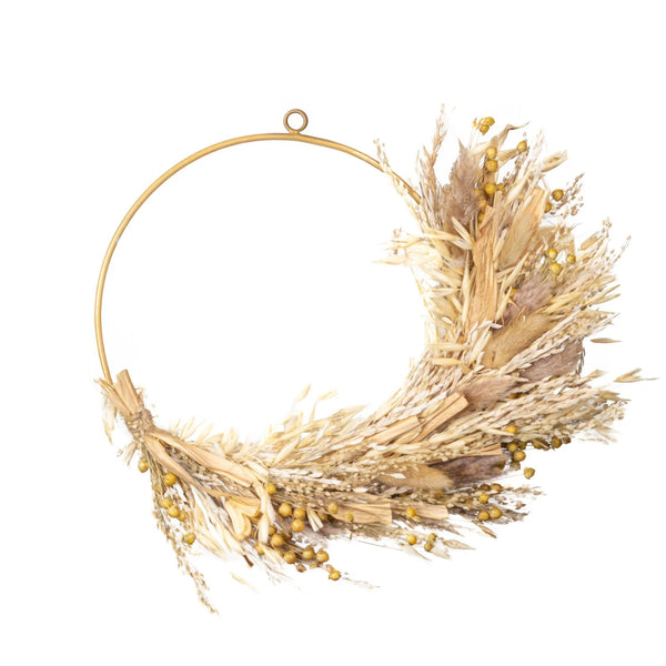 Decorative wreath made of dried wheat and grasses on a white background