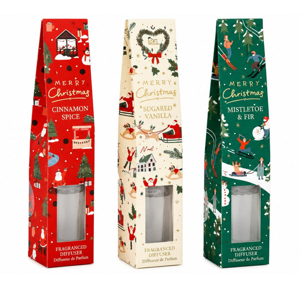 Three Christmas-themed fragranced diffuser boxes standing upright on a white background: red Cinnamon Spice, cream Sugared Vanilla, and green Mistletoe & Fir.