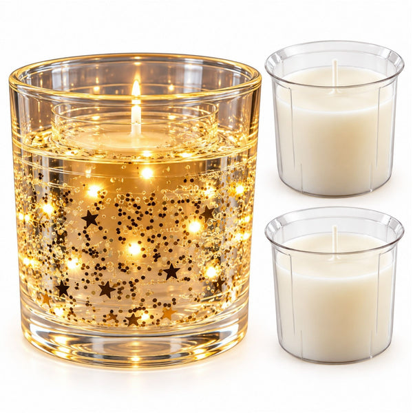 A lit glass candle holder with gold star-shaped glitter and glowing internal lights, shown next to two plain white taper candles in clear holders on a white background.
