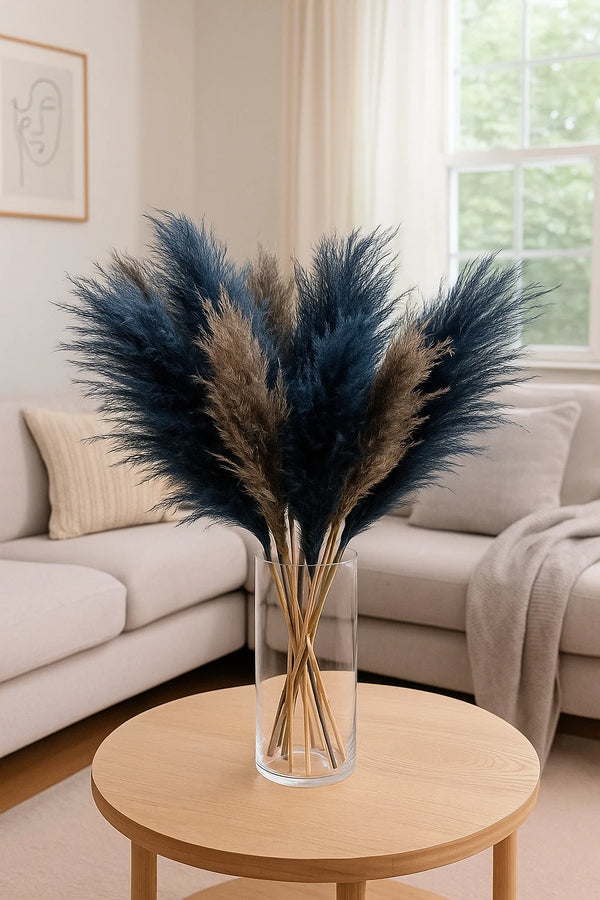 Decorative vase with pampas grass on a wooden coffee table in a living room.