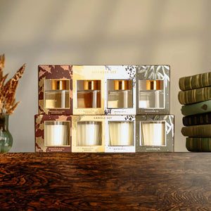 Set of candle boxes on a wooden surface with a neutral background