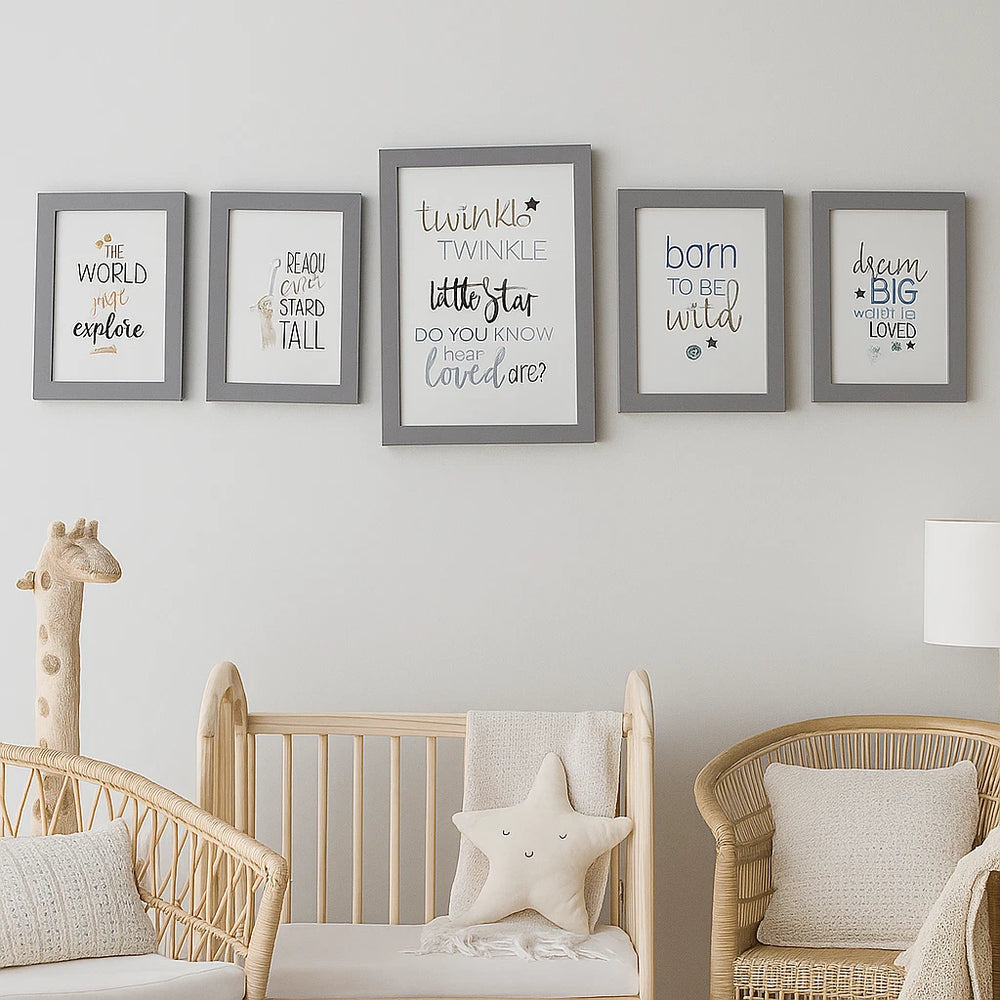 Nursery room with wooden crib, wicker chairs, and framed quotes on the wall.