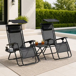 Set of two black folding sun loungers with drinks table
