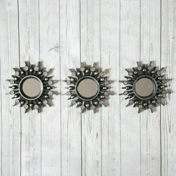 Three round silver wall mirrors displayed together
