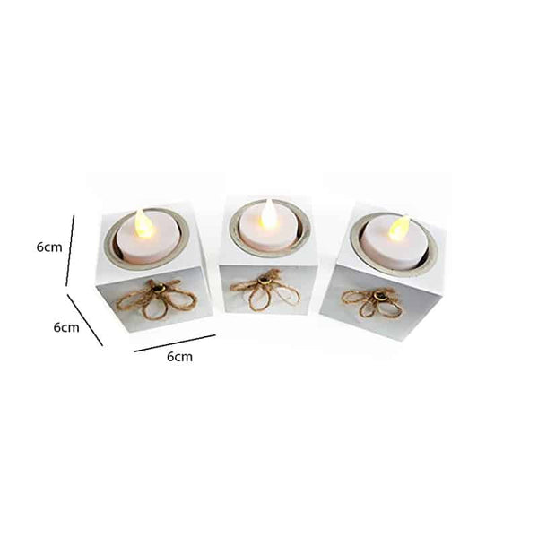 Three shabby chic candle holders on a mantelpiece