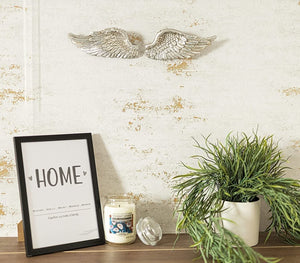 Antique silver angel ornament displayed on a shelf