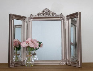 Silver tri-fold dressing table mirror with ornate frame