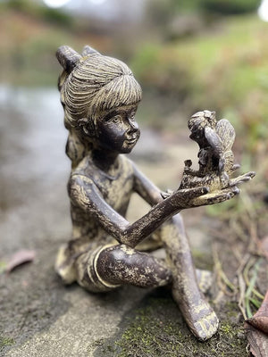 Sitting girl with fairy resin garden statue