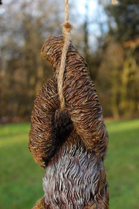 Swinging sloth resin garden ornament