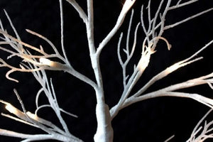 24 warm white LED lights across decorative tree branches