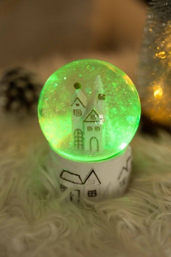 Christmas snow globe with swirling snow and lights