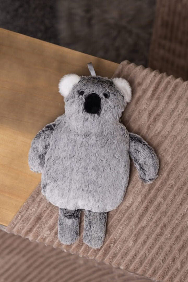 Soft plush koala hot water bottle on bed