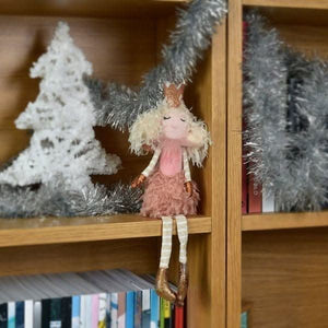 Pink seated fairy decoration displayed on table