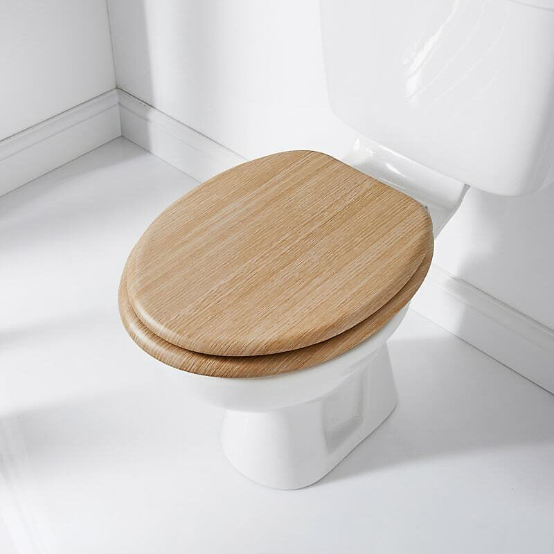 White toilet with a wooden seat in a bathroom setting
