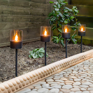 Four LED solar stake lights shown together