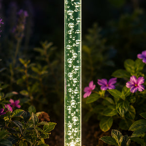 Eight bubble lights arranged around a garden border