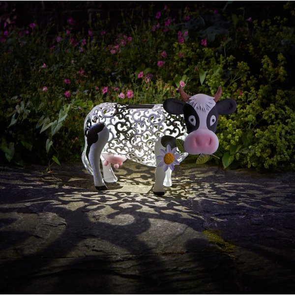Solar cow garden ornament with silhouette lighting
