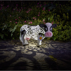 Solar cow garden ornament with silhouette lighting