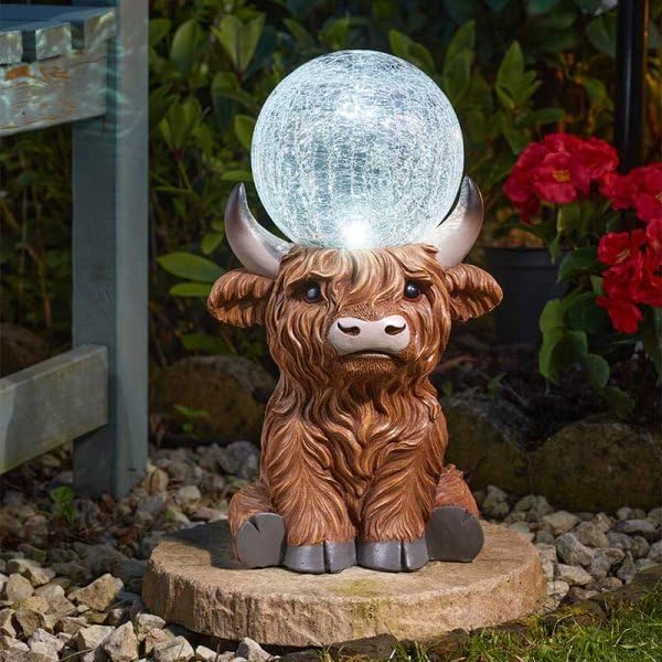 Resin Highland cow LED light displayed in garden