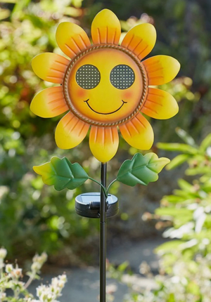 Solar powered flower decoration positioned beside a pathway