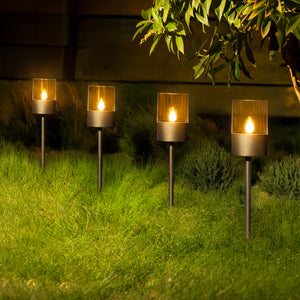 Four black ground spike lights displayed outdoors