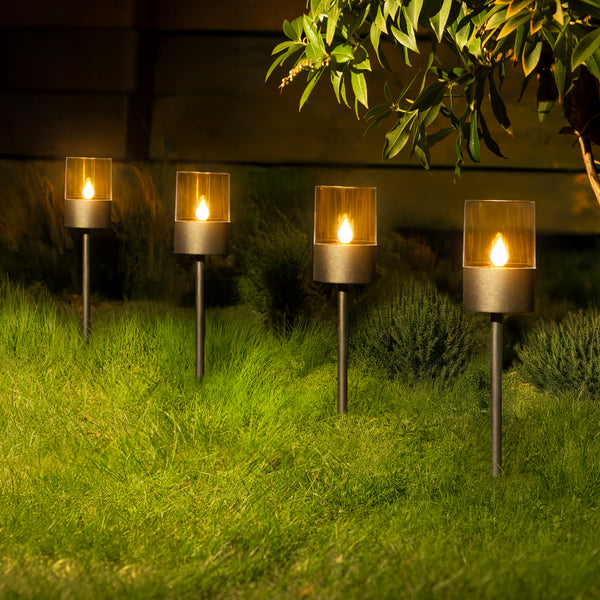 Four black ground spike lights displayed outdoors