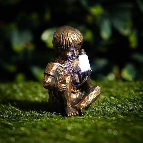 Outdoor boy and girl figurines with glowing lanterns