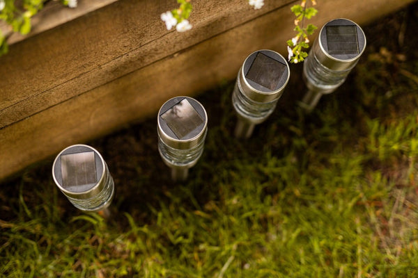 Solar pathway lights displayed in garden border