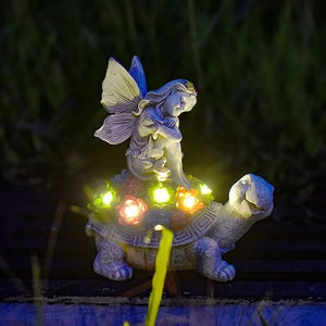 Fairy tortoise garden statue among flowers