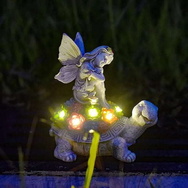 Fairy tortoise garden statue among flowers