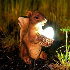 Solar red squirrel garden ornament holding an acorn