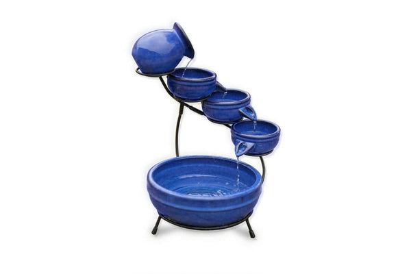 Blue glazed fountain creating flowing water outdoors