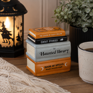 Ceramic wax warmer featuring a haunted book design