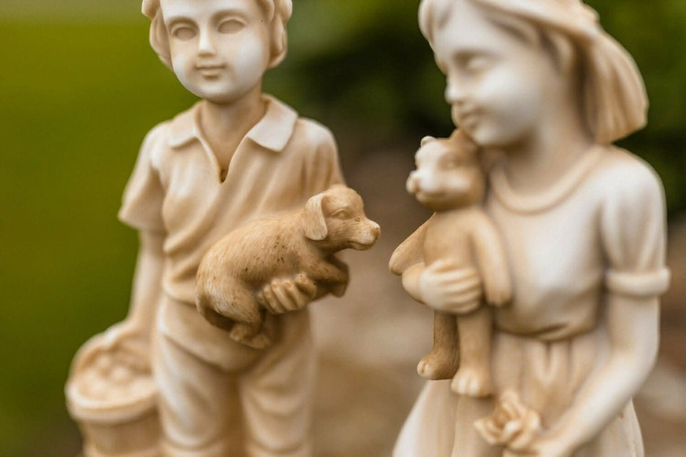 Standing boy and girl garden statues set