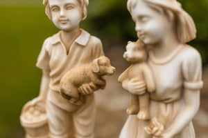 Cream stone effect resin boy and girl figures