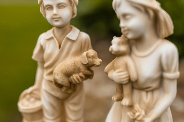 Cream stone effect resin boy and girl figures