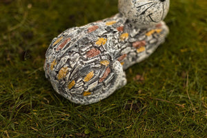 Lightweight resin cat sculpture beside garden greenery