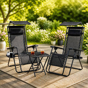 Black garden loungers with adjustable shade canopies