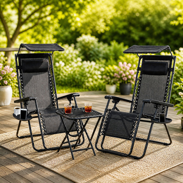 Black garden loungers with adjustable shade canopies