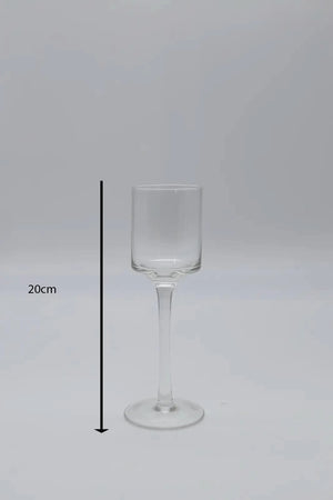 Tall glass candle holders displayed on dining table