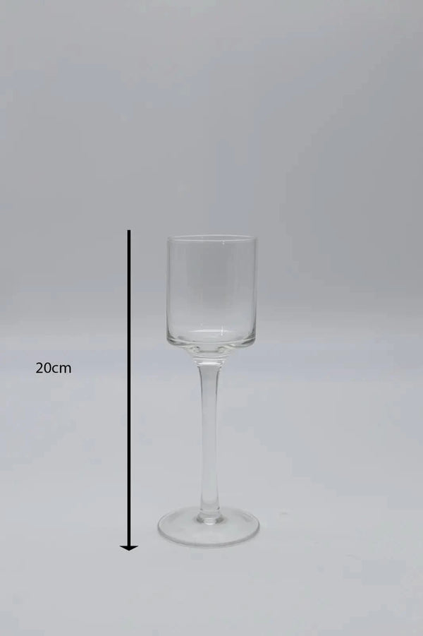 Tall glass candle holders displayed on dining table