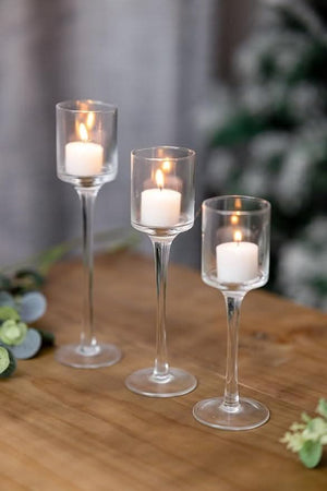 Graduated glass candle holder set displayed together