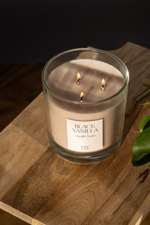 Black Vanilla soy wax candle styled on a side table