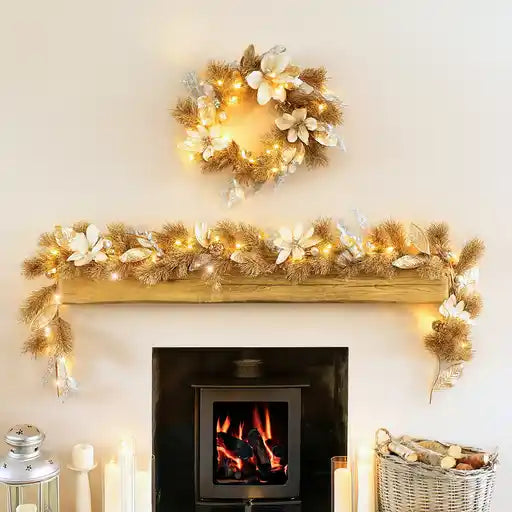 Decorated fireplace mantel with garland, wreath, and candles