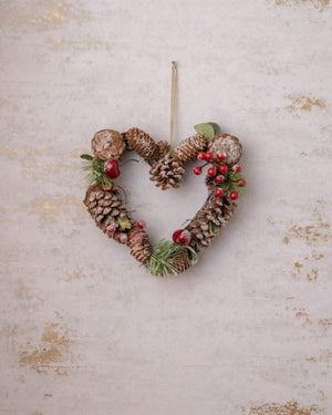 Winter door decoration with pinecones and decorative berries