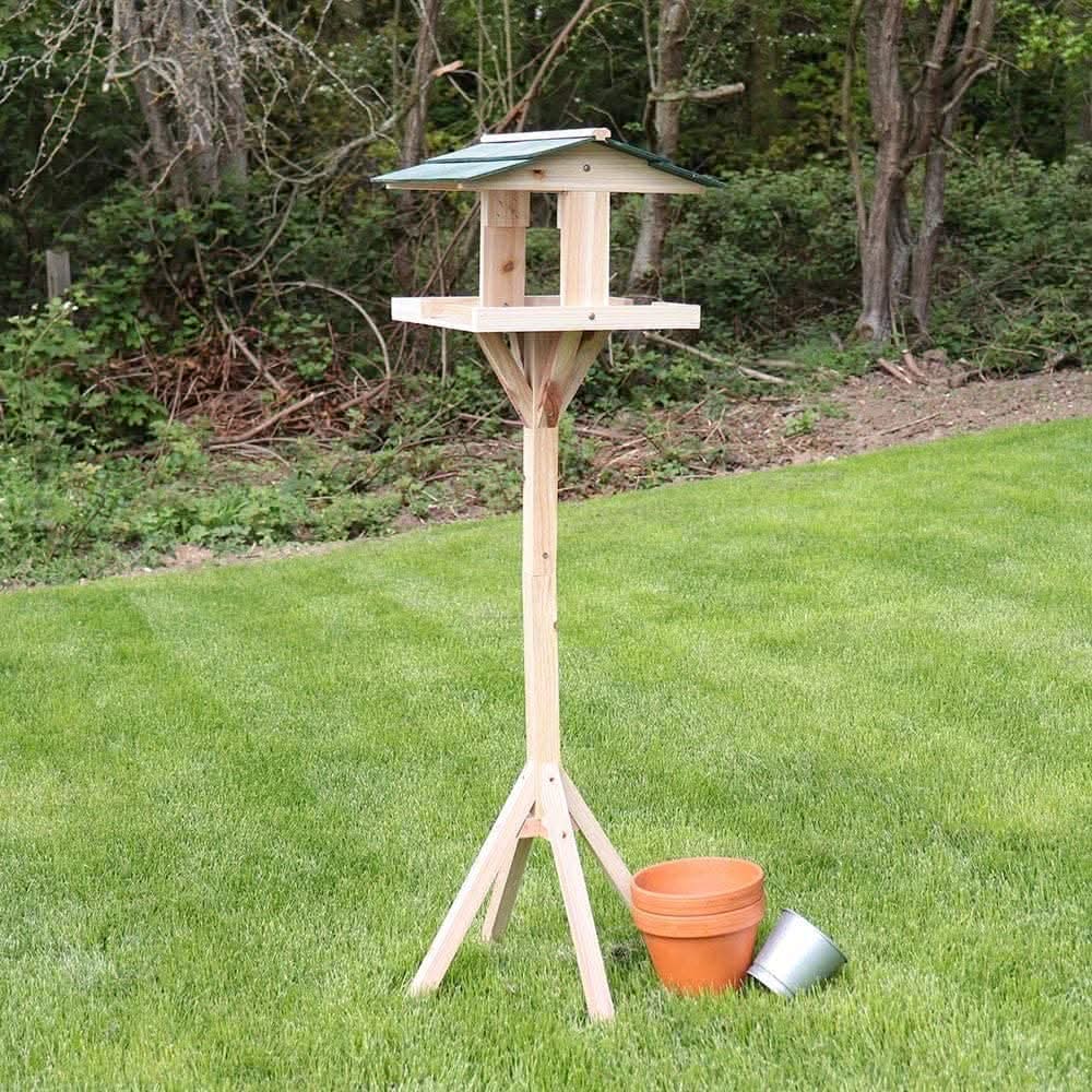 Traditional wooden bird table with freestanding garden base