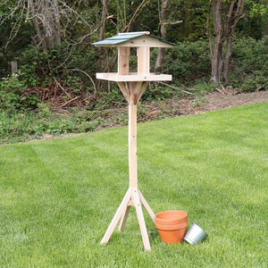 Traditional wooden bird table with freestanding garden base