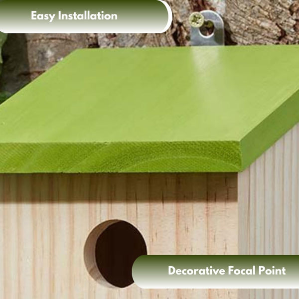 Wooden bird house mounted on garden fence