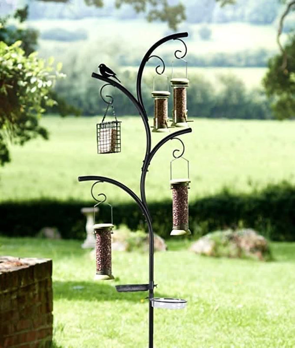 Bird feeder stand with multiple bird feeders in a garden setting